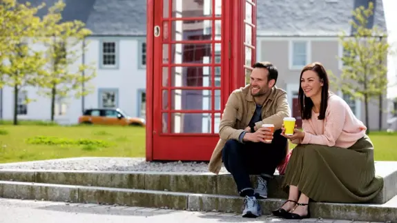 Man And Woman Sitting Outside